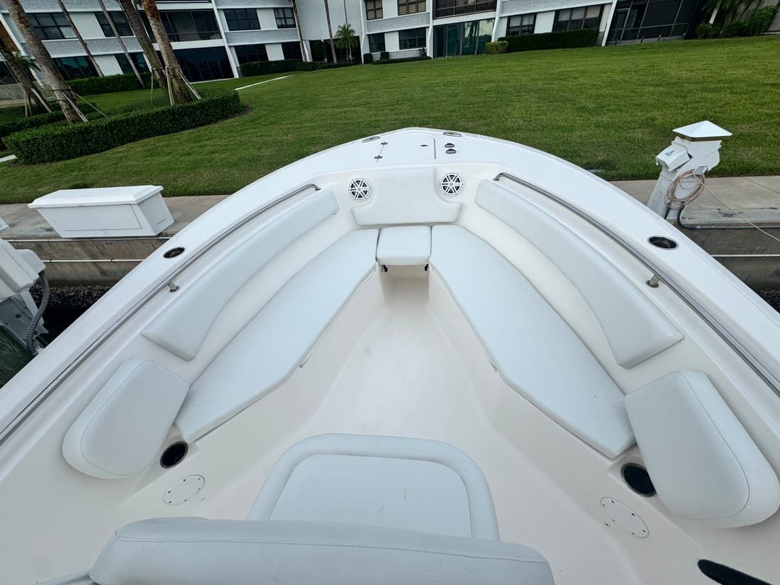 White upholstered bow bolsters and cushions in the forward deck of a bay boat