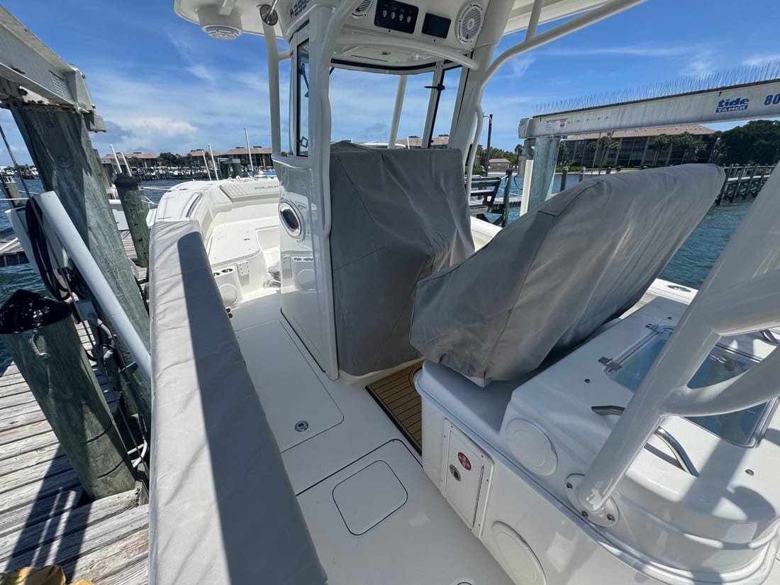 Grey canvas covers over the console and leaning post of a center console at a dock