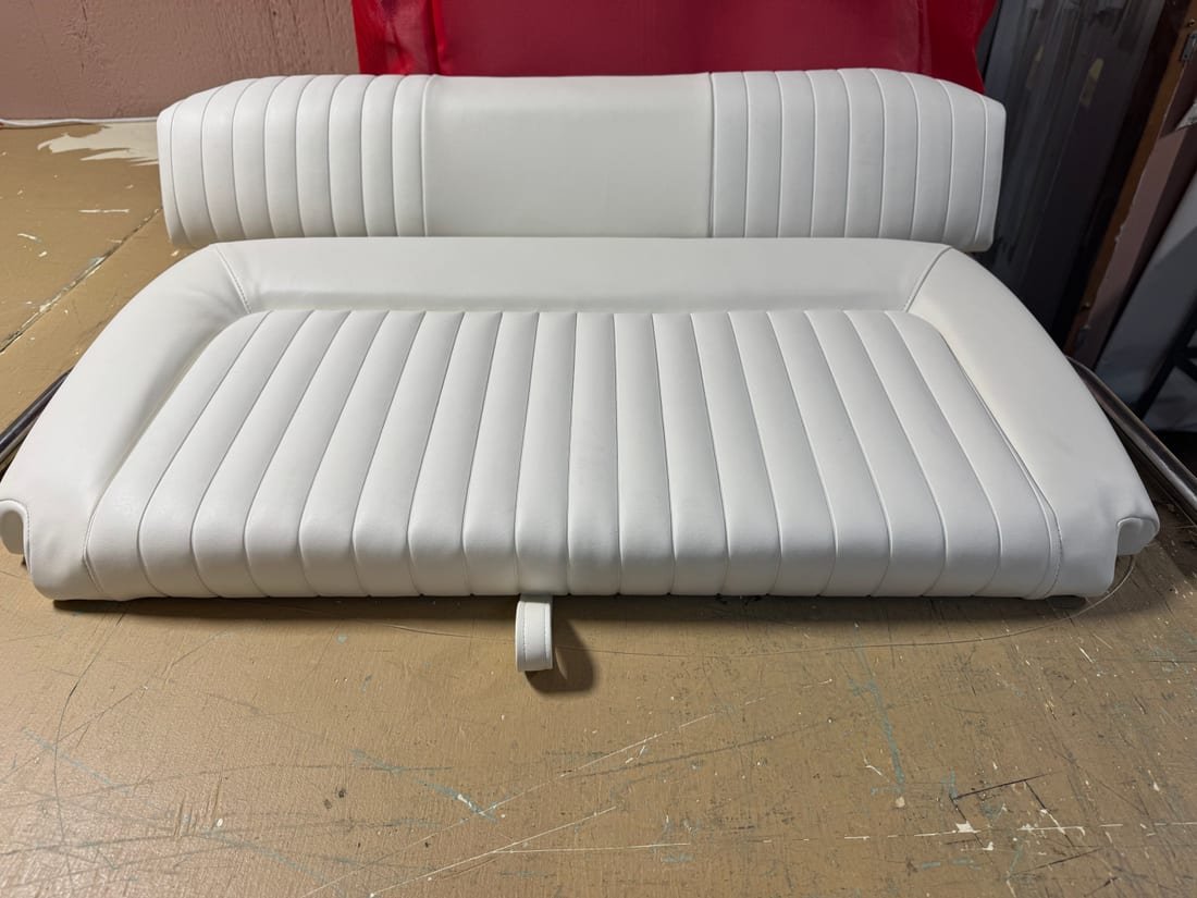 A white channel-pleated bench seat and matching backrest finished in the workshop